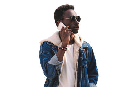 Portrait of african man talking on smartphone isolated on white backgroundの写真素材