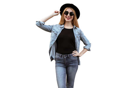 Stylish young woman posing looking away wearing black round hat, jeans jacket isolated on white backgroundの写真素材
