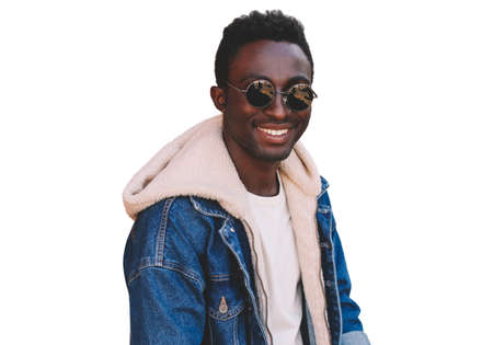 Portrait of happy smiling young african man looking at camera wearing jeans jacket isolated on white backgroundの写真素材