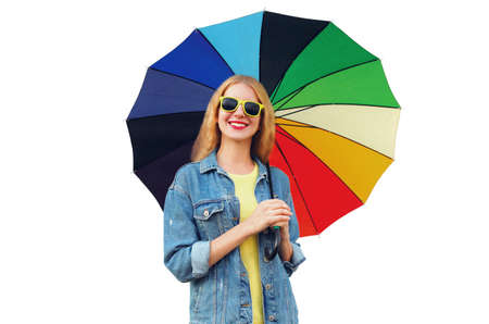 Portrait of happy smiling young woman with colorful umbrella isolated on white backgroundの写真素材