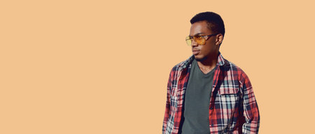 Portrait of stylish african man wearing sunglasses, red plaid shirt, guy looking away isolated on...