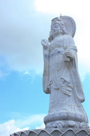 White Guan Yin statue and blue skyの写真素材