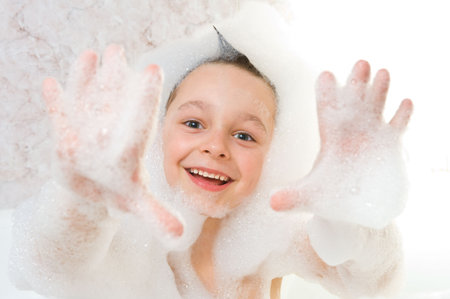 Child playing with shampoo foam 