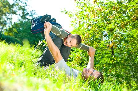 Happy father and son playing outsideの写真素材
