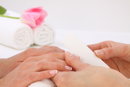 Woman in a nail salon receiving a manicureの写真素材