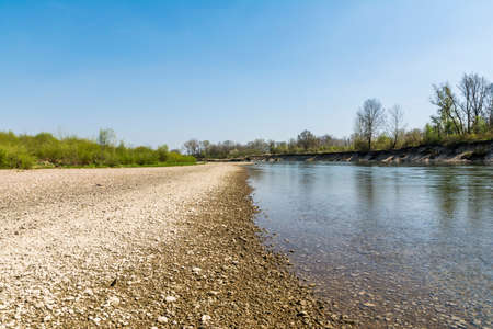 River and stone beach on a beautiful sunny dayの写真素材