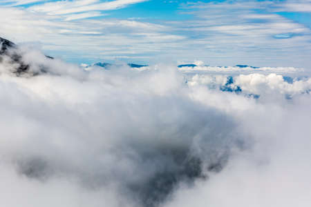 Low clouds covered the valley, only a few peaks protrude aboveの写真素材