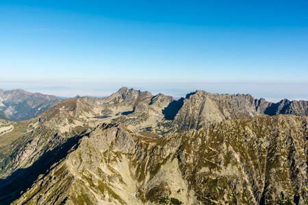 Landscape of mountain ridge and valleys in autumn colorsの写真素材
