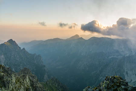 Mountain peaks and valley seen at sunriseの写真素材