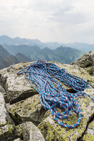 Rope is located on boulders after finishing climb to the top of the mountainの写真素材
