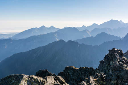 Mountain ranges in the autumn morning fogの写真素材