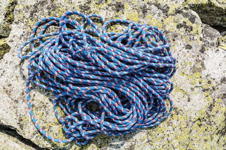Dynamic rope with a pattern red white located on a rock