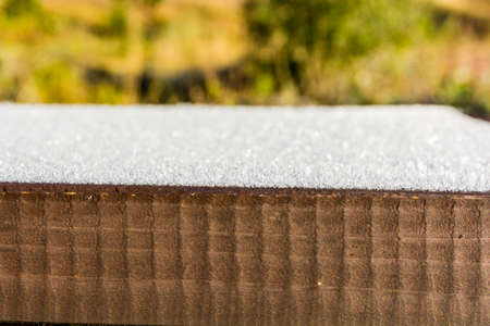 Closeup of frost on a wooden table topの写真素材