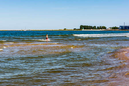 Gdansk, Poland - June 7, 2016: Boy goes to the beach after swimming in the Baltic Sea.のeditorial素材