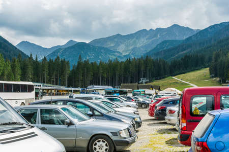 Zuberec, Slovakia - August  20, 2016: Cars and buses in the parking lot under the hood (Rohace - Spalena, Tatra west) of the summer in the mountains.のeditorial素材