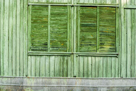 Windows protected by old wooden window shutter.の写真素材