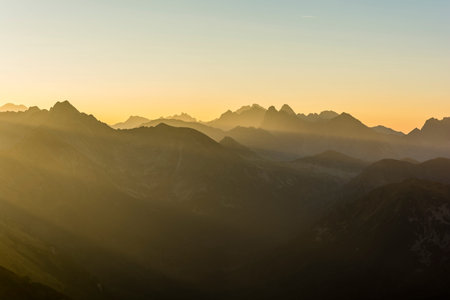 Rising sun beautifully lit up a mountain ridge.