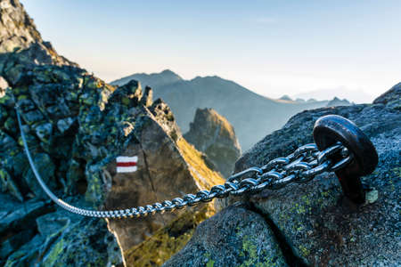 The chain on the red trail in the mountains.の写真素材