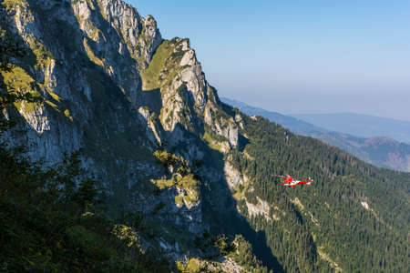 Zakopane, Poland - September 13, 2016: TOPR helicopter in flight in the Tatra Mountains.のeditorial素材