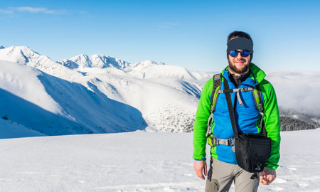 Happy hiker on a background of a winter mountain landscape.