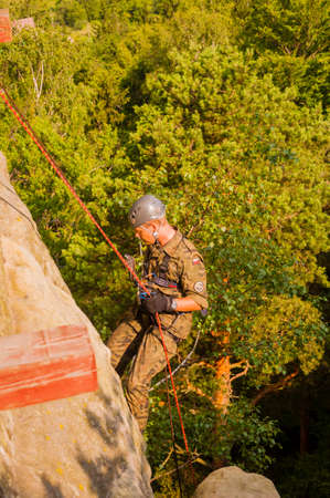 Szczytna, Poland - July 10, 2013: Soldier of the Polish army during the exercises from the rope ride.のeditorial素材