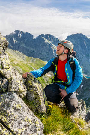 Strbske Pleso, Slovakia - July 10, 2016: Mountaineer in the mountains looks at the way forward.のeditorial素材