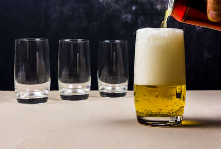 Beer stein filled with beer beverage can.の写真素材