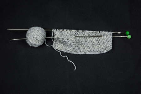 Hand-welded knitting needles and gray scarf starters.の写真素材