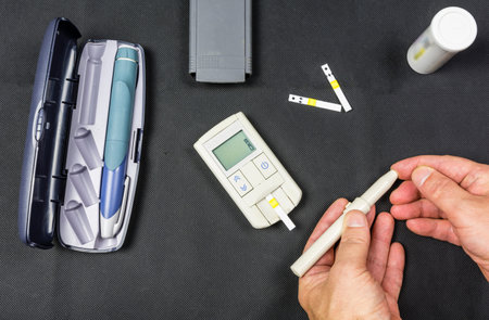 Finger pierced by a needle to measure the sugar level of a diabetic patient.