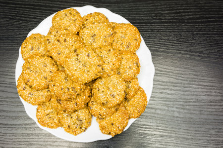 White plate of healthy cookies with seeds.