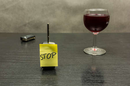 Stop on the car key. So we do not drive vehicles after alcohol - a glass of wine.の写真素材