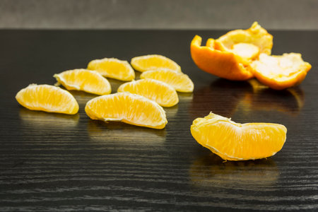 peeled orange and orange skin on the tableの写真素材