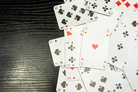 Modern playing cards on a wooden dark table.