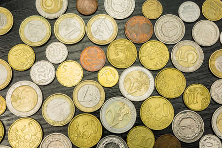 Euro coins and Polish Zloty on a wooden table as a background.の写真素材