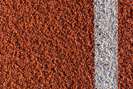 Tartan - plastic on all weather running track with a painted line as a pattern.の写真素材