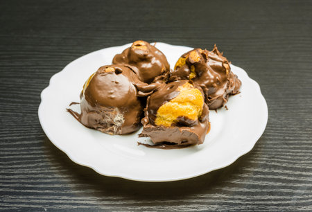 Tasty balls or French dessert - Cake profiterole on a plate.