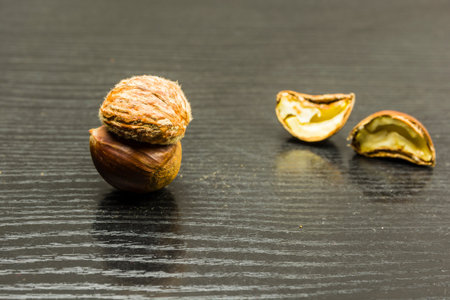 Peeled chestnut all over on a wooden table. In the background, half chestnut is cut.