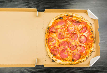 Pizza pepperoni in a cardboard take-away box. View from above.の写真素材