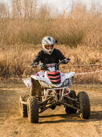 Biskupice Radlowskie, Poland - January 14, 2018: Quad bike driver in the rays of the setting sun.のeditorial素材