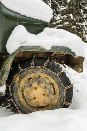 Zdiar, Slovakia - February 11, 2018: Snow chains mounted on the wheel of a truck. The Barum tire on the rim.のeditorial素材
