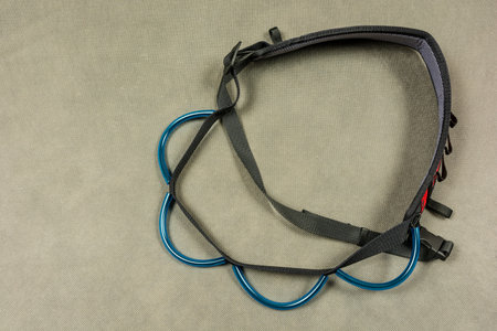 Gear loop (bandolier) for climbing on a gray background.
