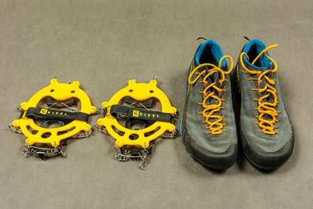 Niedomice, Poland - February 14, 2018: The presentation approach shoes and anti-slip crampons.のeditorial素材