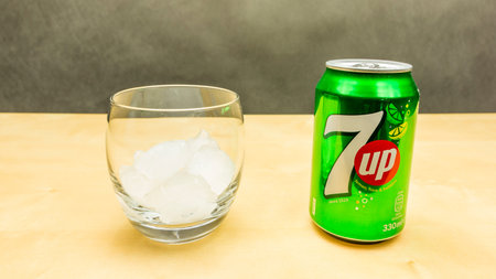 Niedomice, Poland - March 09, 2018: A can of 7up drink and a glass of ice.