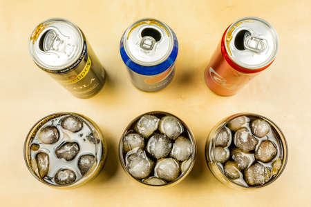 Niedomice, Poland - March 09, 2018: Comparison of a cola drink from producers: Pepsi, Coca-Cola and Schweppes. Cola was poured into glasses with ice cubes.のeditorial素材