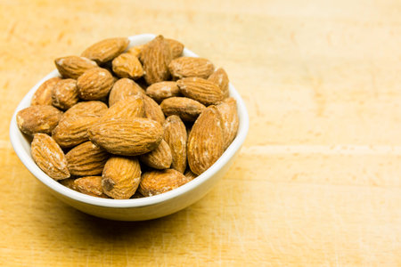 Raw shelled almond seeds in a bowl.