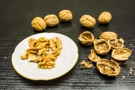 Peeling ripe walnuts on the table.の写真素材