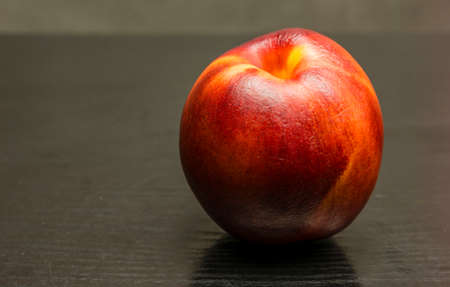 Prunus persica var. nucipersica (nectarine) on a wooden background.の写真素材