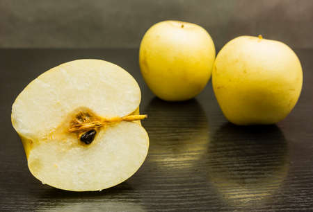 Nashi pear (pyrus pyrifolia) - cross section. On a wooden background.の写真素材