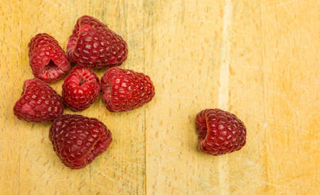 Top view of ripe raspberries on wooden board.の写真素材