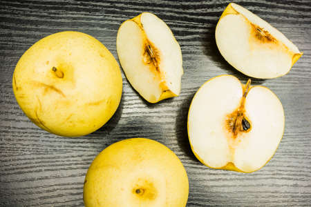 Top view of a delicious nashi pear - whole and cut into pieces.の写真素材